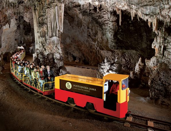 Tourist train in Postojna Cave taking visitors through the magnificent underground world.