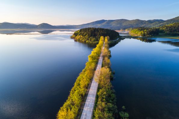 Lake Cerknica, the largest intermittent lake in Europe, with wide grasslands and a water surface on a karst field.